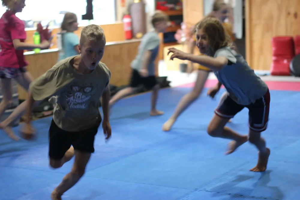 Games during teens functional fitness class in Eltham Australia • Kids playing a fitness game to build strength and agility in Australia