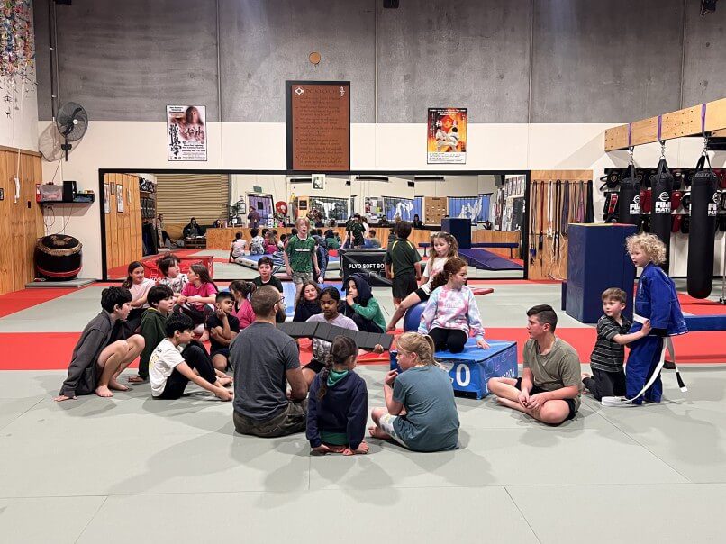 fitness coach encouraging kids during a group class in eltham australia 1 1 fitness coach encouraging kids during a group class in eltham australia 1 1