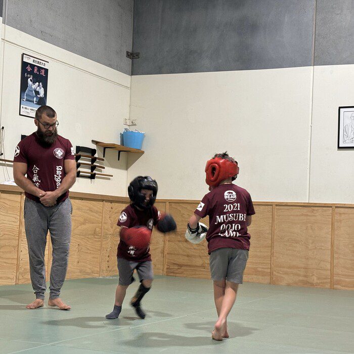 kids martial arts sparring at eltham martial arts academy Instructor Willem supervising kids during a martial arts sparring session at Eltham Martial Arts Academy